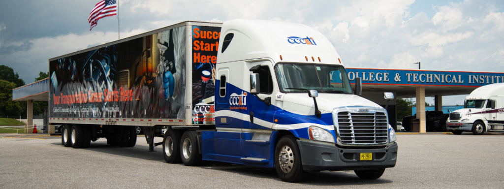 A parked semi truck with CCC&TI logo and advertisement.